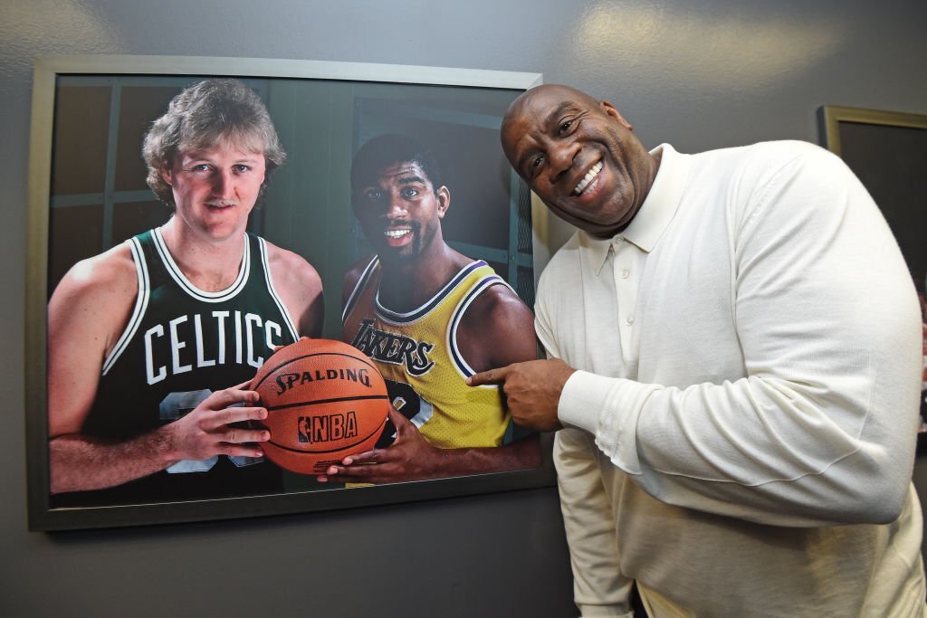 NBA legend Magic Johnson poses with a portrait of him and Larry Bird on February 23, 2020 at STAPLES Center in Los Angeles, California.