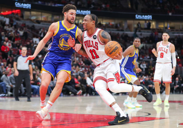 Klay Thompson fouls DeMar DeRozan during a game between the Golden State Warriors and the Chicago Bulls.