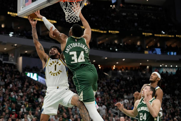 Giannis Antetokounmpo blocks Obi Toppin's shot during a game between the Bucks and Pacers.