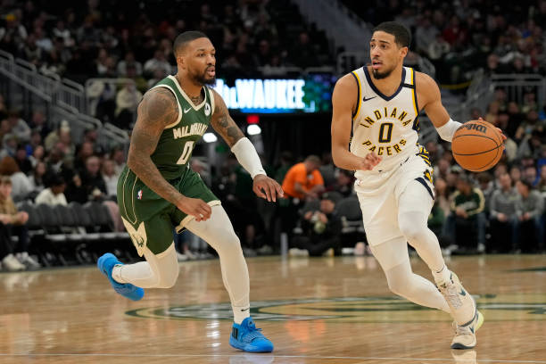 Tyrese Haliburton dribbles against Damian Lillard during a game at Fiserv Forum on January 01, 2024.