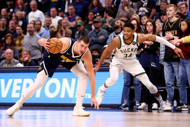 Giannis Antetokounmpo of the Bucks defends Nikola Jokic of the Nuggets at Ball Arena on January 29, 2024 in Denver, Colorado.