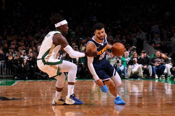 Jamal Murray dribbles the ball for Denver Nuggets against Boston Celtics at TD Garden in Boston, Massachusetts.