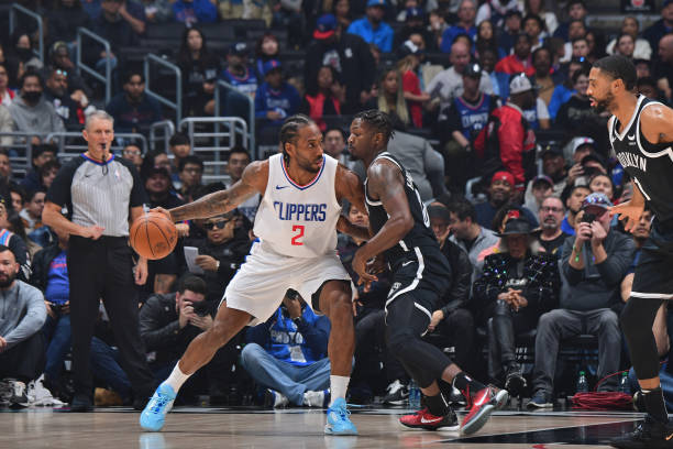 Kawhi Leonard #2 of the Clippers dribbling the ball during a game against the Nets on January 21, 2024 at Crypto.Com Arena in LA.