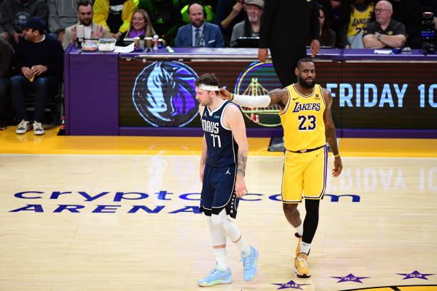 LeBron James (#23) of the Lakers interacts with Luka Doncic (#77) of the Mavericks at Crypto.Com Arena in LA.