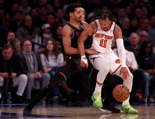 Jordan Poole #13 of the Wizards and Jalen Brunson #11 of the Knicks battling at Madison Square Garden on January 18, 2024.