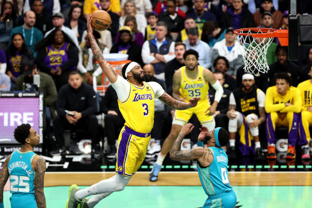 Anthony Davis #3 of the Los Angeles Lakers dunks the ball during the first half of a game against the Charlotte Hornets at Spectrum Center.