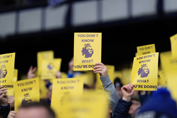 Everton fans hold up protest leaflets during the Premier League match between Everton and Tottenham Hotspur at Goodison Park on February 3, 2024.