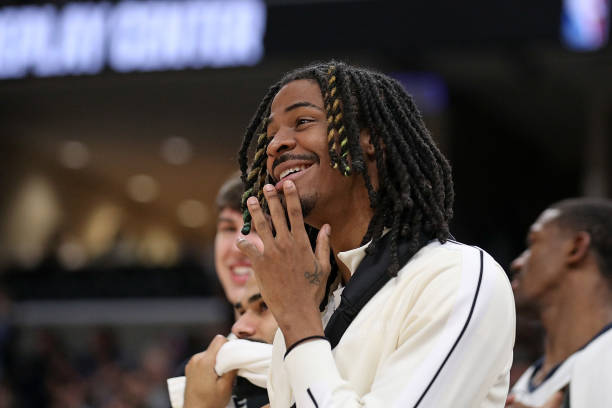 Ja Morant of the Grizzlies watching the game against the Bucks at FedExForum on February 15, 2024 in Memphis, Tennessee.