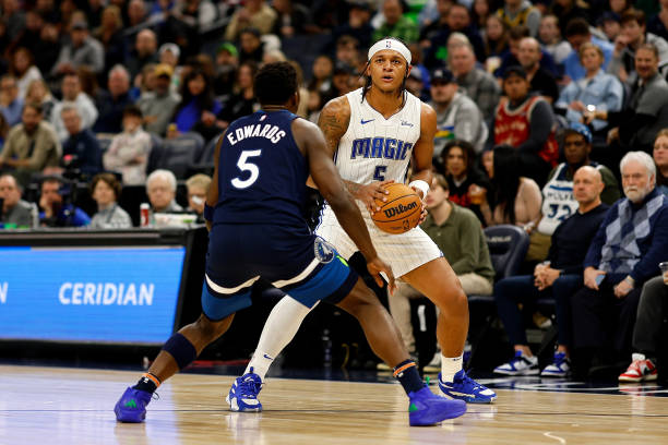 Paolo Banchero of the Magic competes while Anthony Edwards of the Timberwolves defends in the third quarter at Target Center on February 02, 2024 in Minneapolis, Minnesota.
