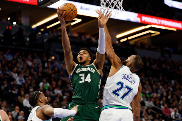 Giannis Antetokounmpo of the Bucks goes up for a shot against Rudy Gobert of the Timberwolves in the fourth quarter at Target Center on February 23, 2024 in Minneapolis, Minnesota.