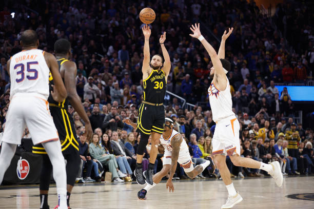 Steph Curry of the Warriors makes a go-ahead three-point basket late in the fourth quarter against the Phoenix Suns at Chase Center on February 10, 2024 in San Francisco, California.