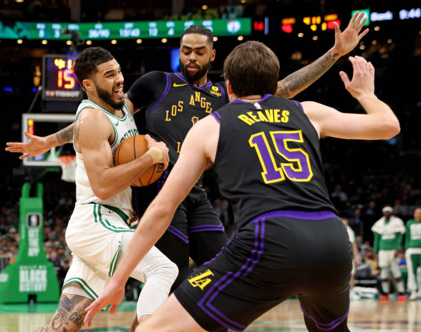 Austin Reaves and D'Angelo Russell of the Lakers defend Jayson Tatum of the Celtics during the game at the TD Garden.