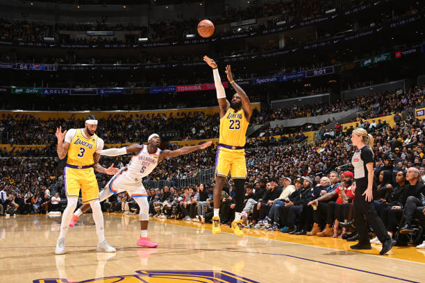 LeBron James of the Lakers shoots a three point basket during the game against the Thunder at the Crypto.Com Arena.